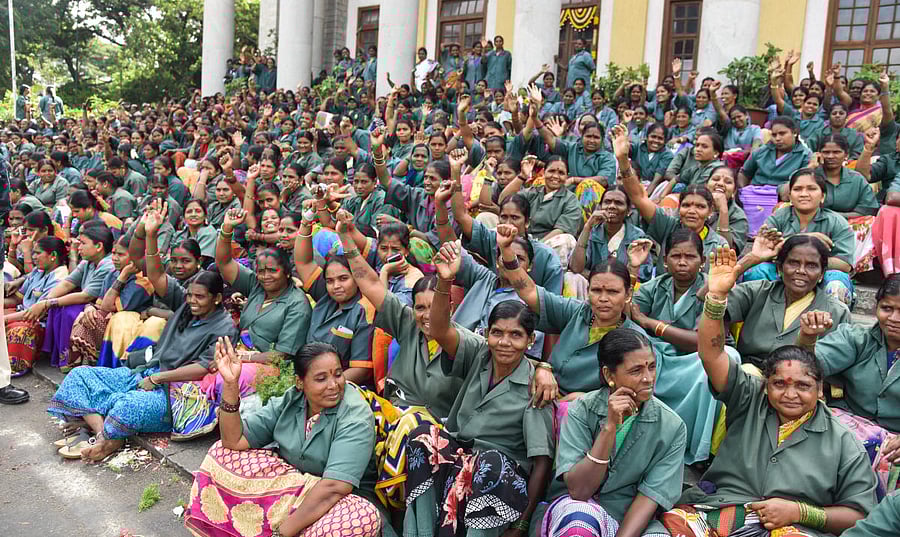 The pourakarmikas on Monday staged a protest in front of the Town Hall seeking fulfilment of their various demands. DH photo/ S K Dinesh