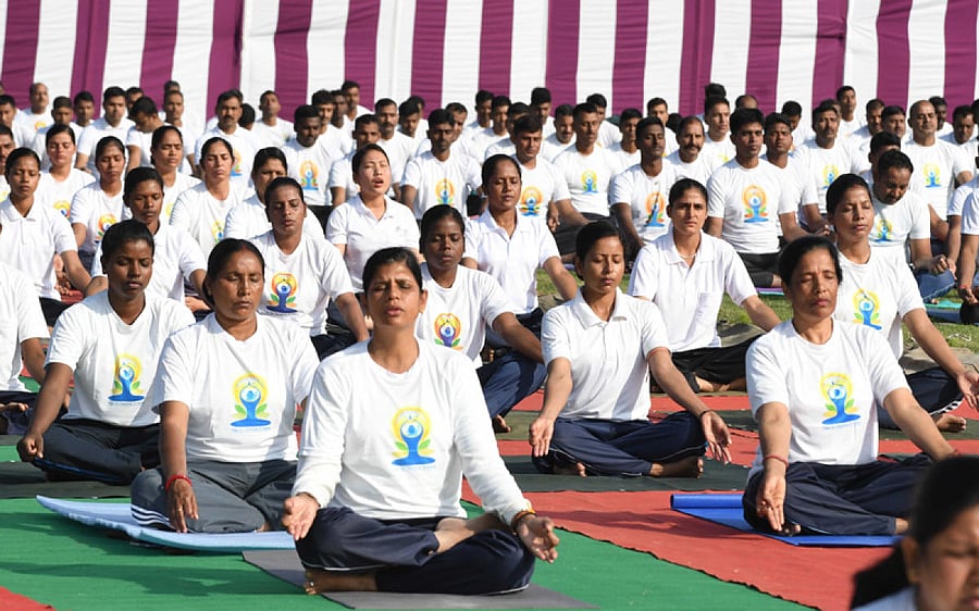 Paramilitary officers and soldiers of Central Reserve Police Force (CRPF) perform Yoga exercises at their base camp in Humhama outskirts of Srinagar, on Friday. DH photo