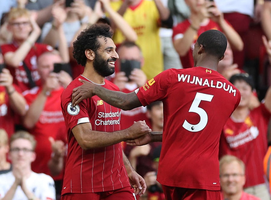 Liverpool's Mohamed Salah (left) celebrates with Georginio Wijnaldum after scoring their third goal against Arsenal on Saturday. Reuters