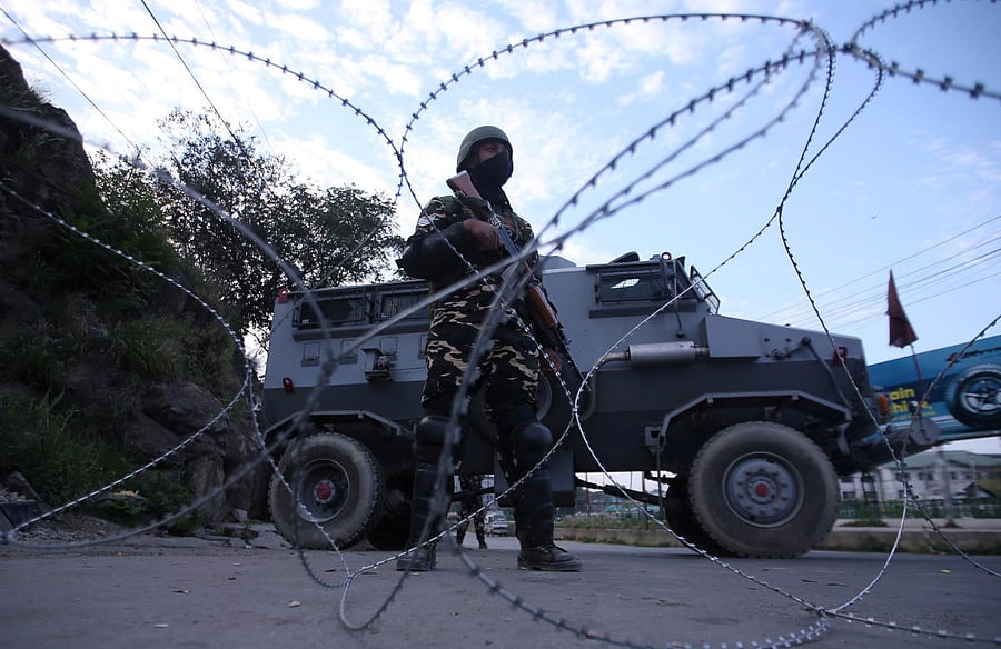 An Indian security personnel stands guard on a deserted road during restrictions after scrapping of the special constitutional status for Kashmir by the Indian government, in Srinagar. FILE PHOTO/REUTERS