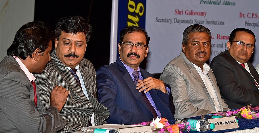 Dr Ramaraju H K, chief of civil engineering department of Dayananda Sagar College of Engineering has a word with Bescom managing director and alumnus of the college M B Rajesh Gowda during the seminar as managing director of Kudremukh Iron Ore Company MV