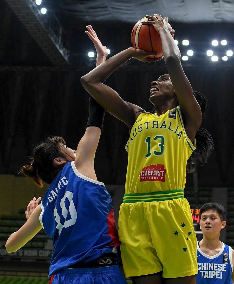 Australia’s Ezi Magbegor (right) attempts to shoot past Pei Chen Tsai of Chinese Taipei during their FIBA Women’s Asia Cup Division A clash on Friday. DH PHOTO/ BH SHIVAKUMAR