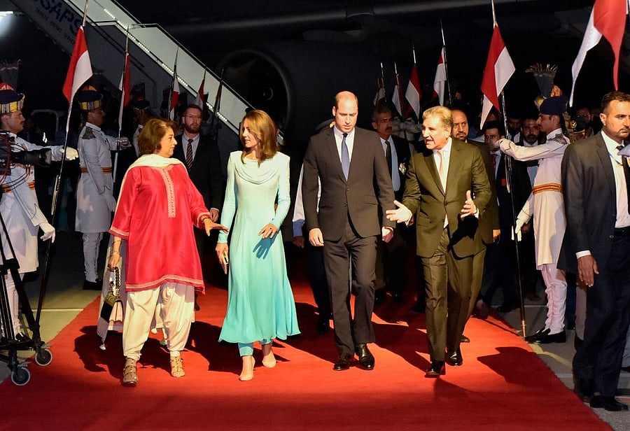 Britain's Prince William, Duke of Cambridge (Center R) and his wife Britain's Catherine, Duchess of Cambridge (Center L) are welcomed by Pakistan's Foreign Minister Shah Mehmood Qureshi (R) upon their arrival at the Pakistan's Nur Khan military airbase in