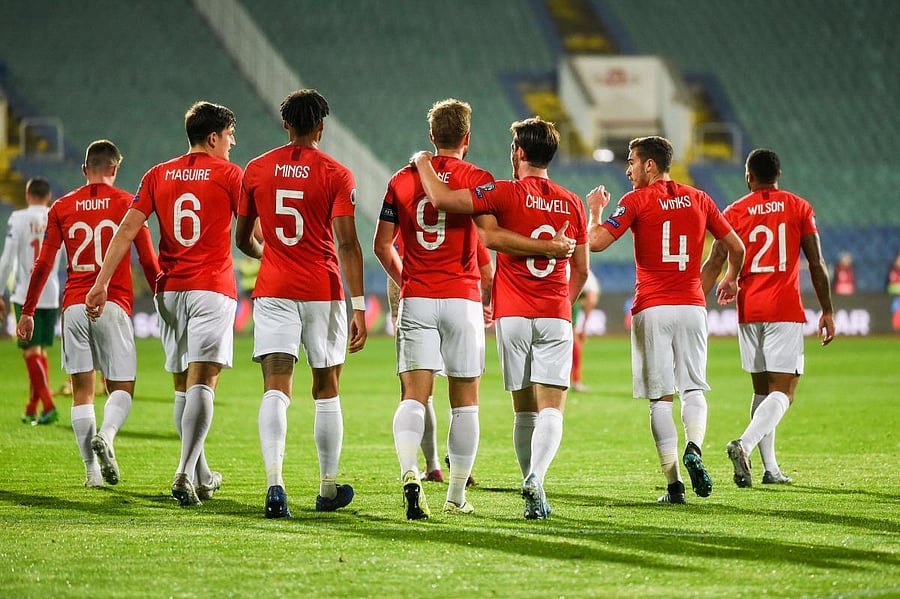 England's forward Harry Kane (C) celebrates with his teammates after scoring a goal during the Euro 2020 Group A football qualification match between Bulgaria and England due to incidents with fans, at the Vasil Levski National Stadium in Sofia on October
