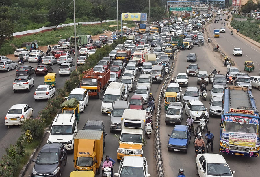 Vehicles stuck in a huge traffic jam on airport road near Hebbal during the rally of Congress leader D K Shivakumar in Bengaluru on Saturday. DH Photo/Janardhan B K