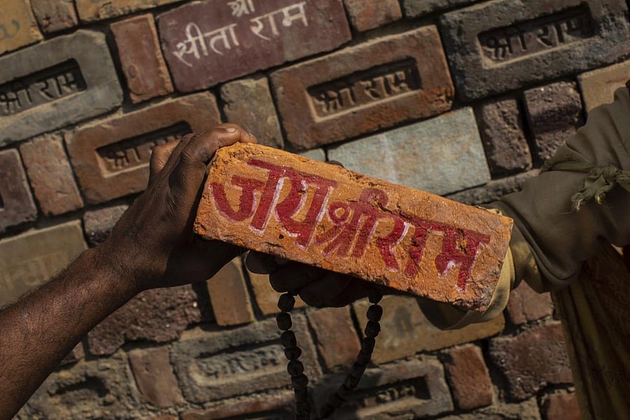 "Jai Shree Ram" (Victory to Lord Ram) as bricks of the old Babri Mosque are piled up in Ayodhya (AP Photo)