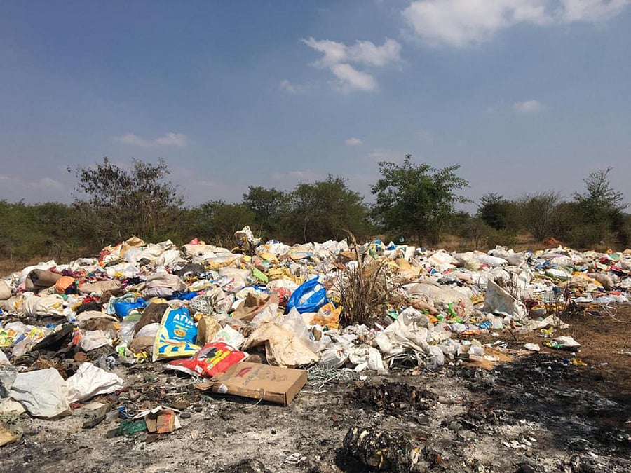Hospital waste from Kerala dumped in an open space in Nanjangud taluk. Trucks come in the middle of the night and empty tonnes of such waste every day. dh photo