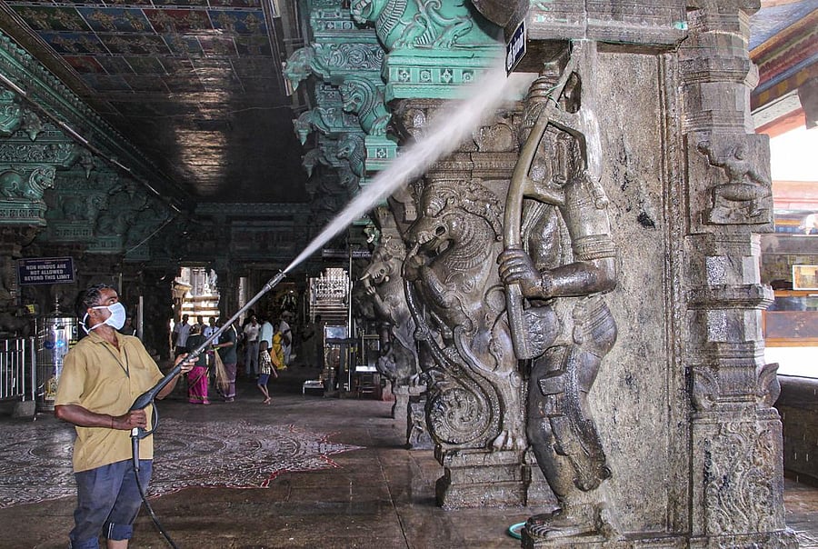 A worker sprays disinfectant to mitigate the coronavirus pandemic, at Meenakshi Amman Temple in Madurai. (PTI Photo)