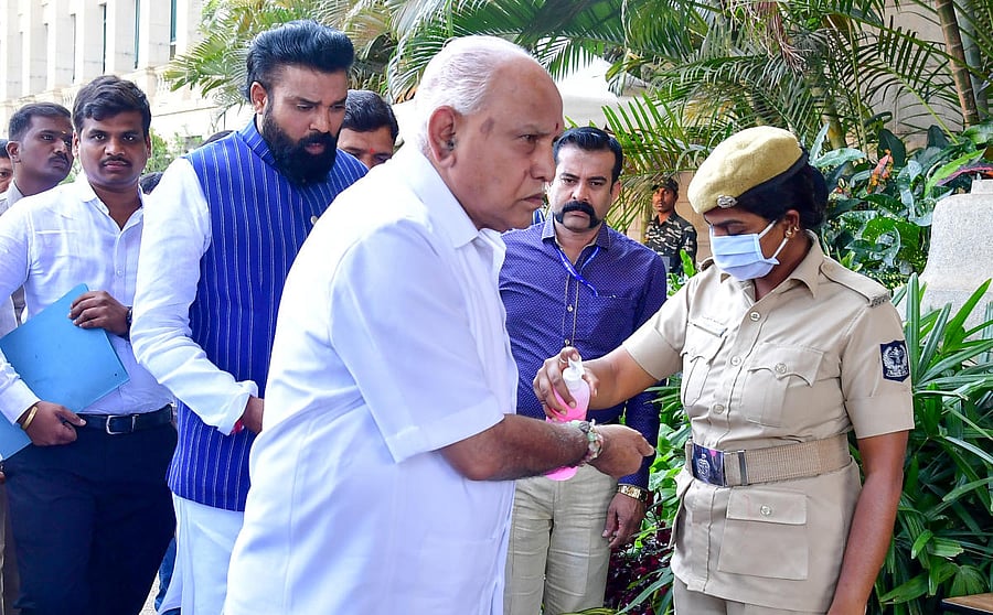 CM Yediyurappa uses a hand sanitizer before entering Vidhana Soudha on Thursday. DH Photo.
