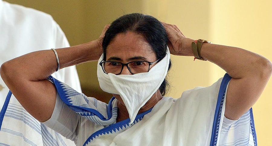 West Bengal Chief Minister Mamata Banerjee covers her mouth with a piece of cloth during a press conference on coronavirus, at Nabanna (State Secretariat) in Kolkata. (PTI Photo)