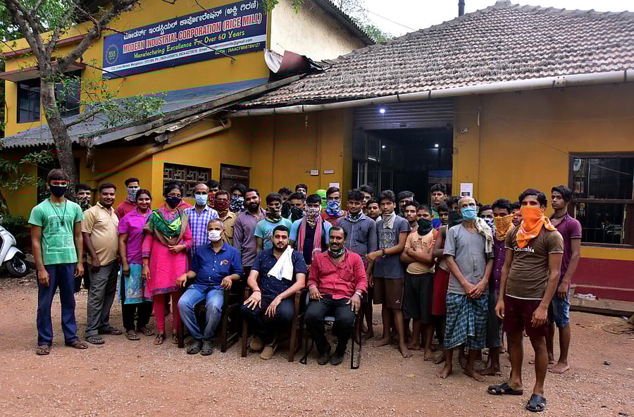 Entrepreneur Ullal Venkatraya Mallya (seated in middle) with employees at Modern Industrial Corporation's rice mill near Urva market in Mangalauru. DH Photos/Govindraj Javali