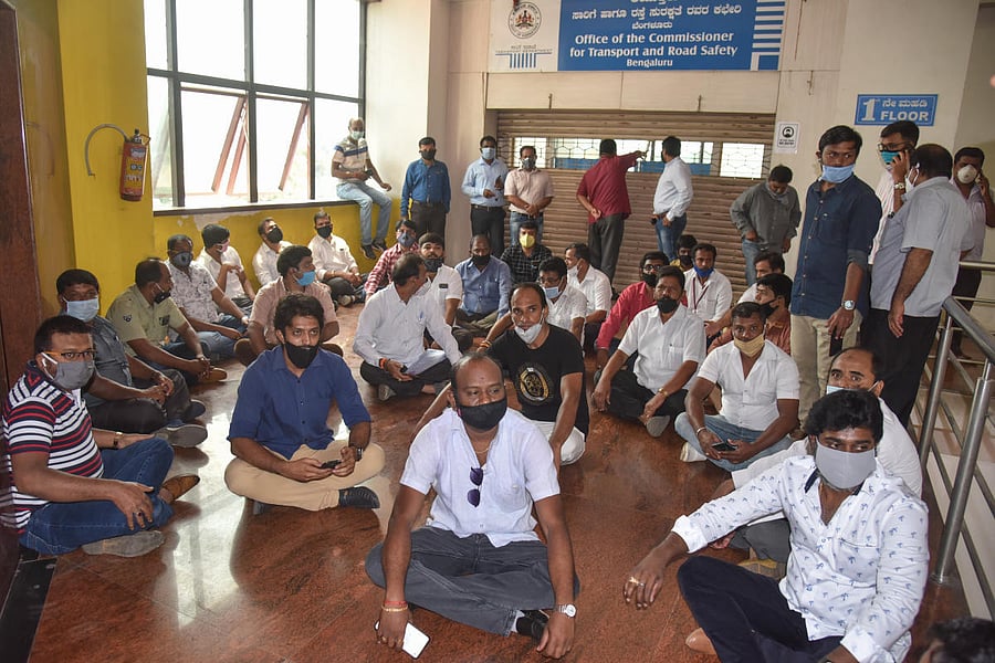 Members of KSTOA stage protest demanding waiver of vehicle tax and COVID-19 relief in front of Transport and Road Safety Commissioner Office in Bengaluru on Monday. Photo by S K Dinesh