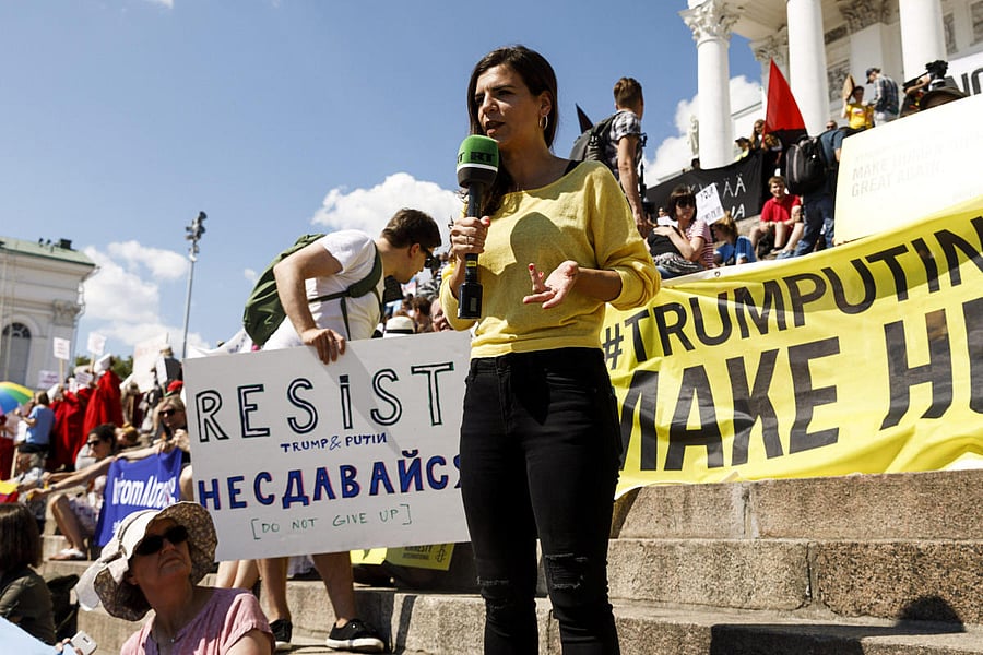 Russia Today reporter speaks at the Helsinki Calling demonstration against the Helsinki Summit 2018 in Helsinki, Finland July 15, 2018. Lehtikuva/Roni Rekomaa/Reuters