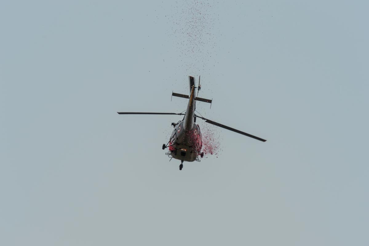 An Indian Air Force (IAF) helicopter throws rose petals from the sky to pay tribute to the medical staff (AFP Photo)