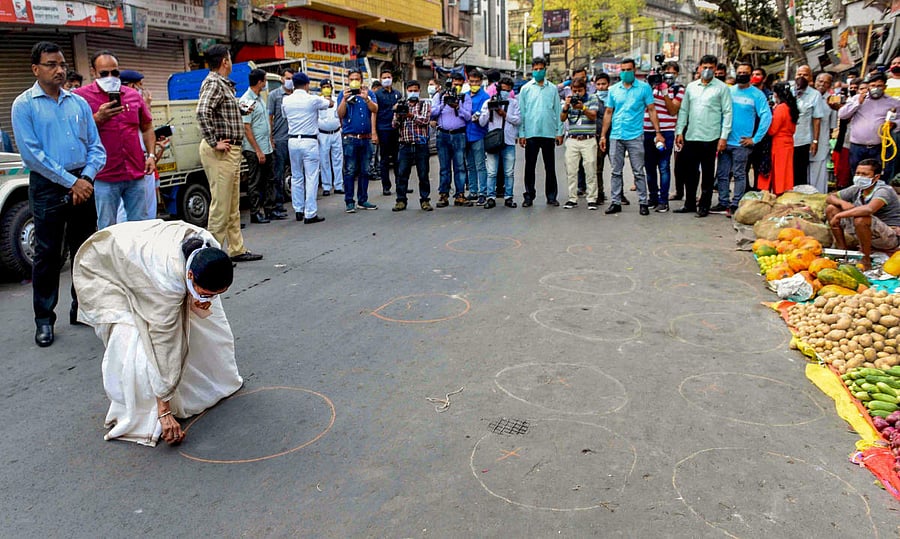 West Bengal Chief Minister Mamata Banerjee draws circles to create awareness about maintaining social distance, in the wake of coronavirus pandemic (PTI Photo)
