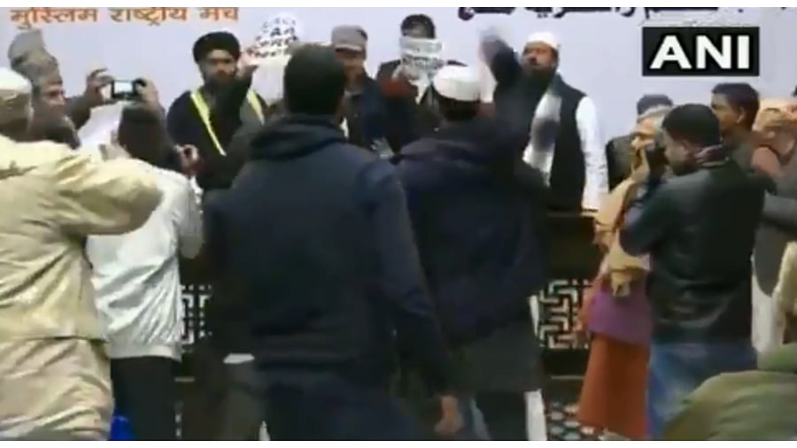 As soon as the speakers, including RSS leader Indresh Kumar, arrived on the dais, the protesters who were sitting in the front row rose on their feet and shouted slogans. (Twitter video screengrab/@ANI)