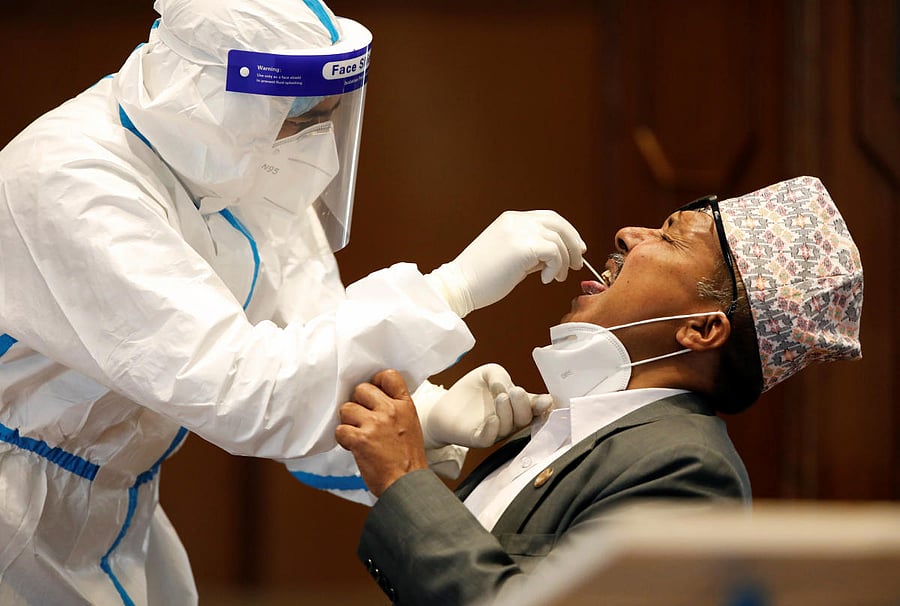 A Nepalese lawmaker takes polymerase chain reaction (PCR) test for the coronavirus disease (COVID-19), at the Parliament in Kathmandu, Nepal (Reuters Photo)