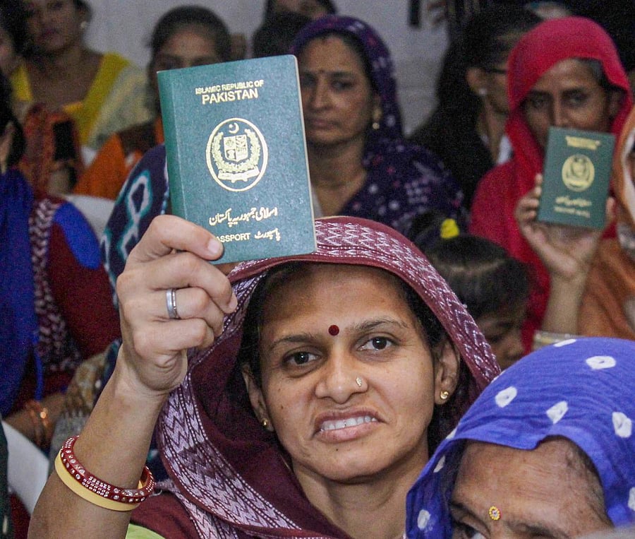  Hindu refugees who migrated from Sindh province of Pakistan display their passports as they support the Citizenship Amendment Act. PTI