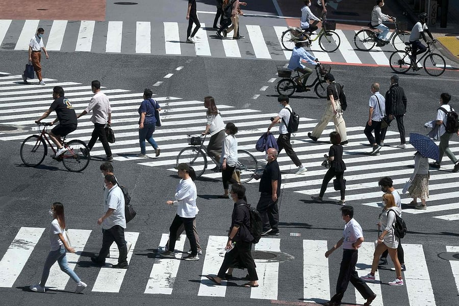People wearing face masks amid concerns over the spread of the COVID-19 coronavirus cross the Shibuya crossing in Tokyo on May 17, 2020. Credit: AFP Photo