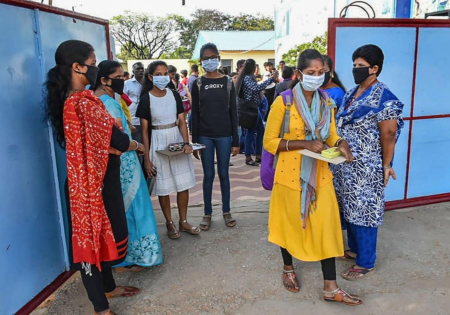 Students wear mask to mitigate the spread of coronavirus as they arrive to appear for SSC public examinations examination. (PTI Photo)