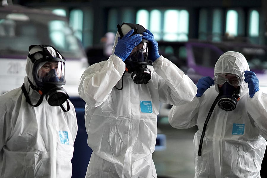 Members of the Thai Airways crew prepare themselves before disinfecting the cabin of an aircraft of the national carrier during a procedure to prevent the spread of the coronavirus at Bangkok's Suvarnabhumi International Airport. (Reuters Photo)