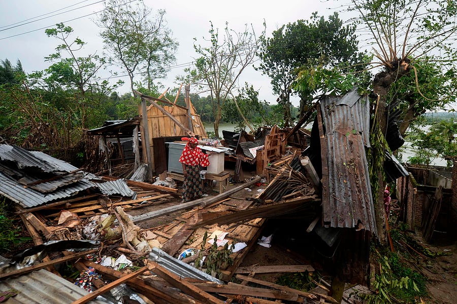 A woman stands amidst the debris of her house damaged by cyclone Amphan in Satkhira on May 21, 2020. (AFP photo)