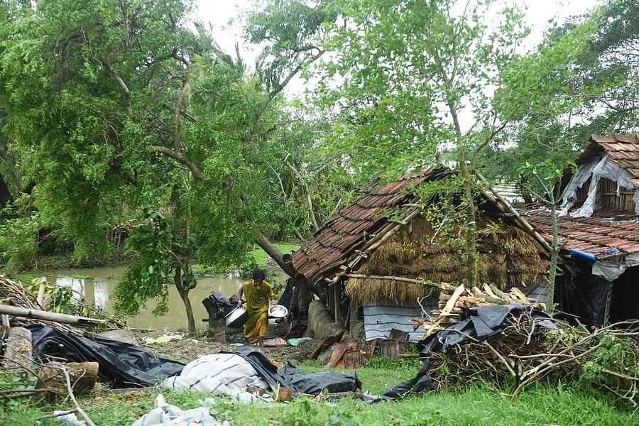 A woman salvages items from her house damaged by cyclone Amphan in Midnapore, West Bengal. (AFP Photo)