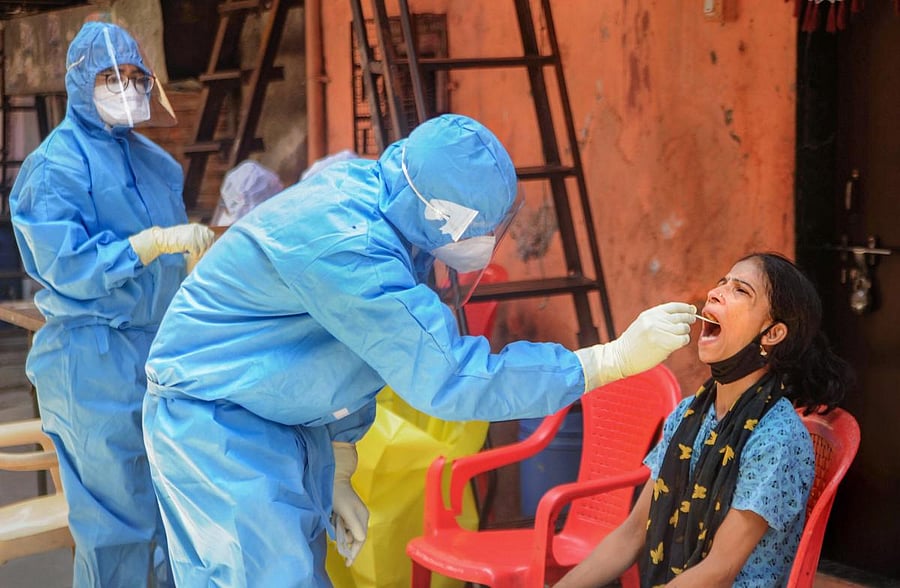 A healthcare worker collects swab sample (PTI Photo)