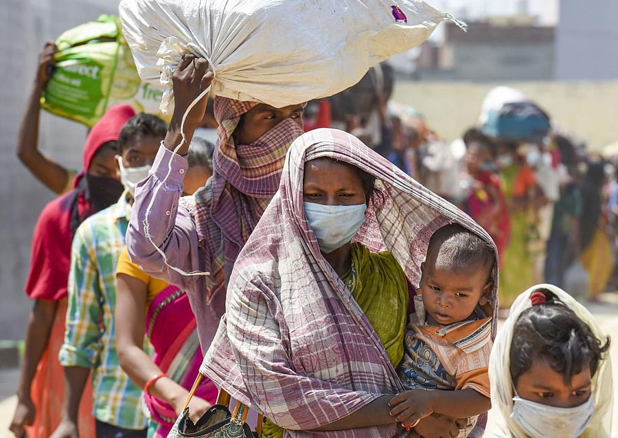 Dadri: Migrant workers wait in a queue while being lodged at a camp by the Uttar Pradesh government, during ongoing COVID-19 lockdown, at Dadri in Gautam Buddha Nagar district, Wednesday, May 20, 2020. (PTI Photo/Atul Yadav) (PTI20-05-2020_000308A)