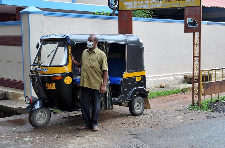 An auto driver waits for customers at Basavanahalli in Chikkamagaluru district.