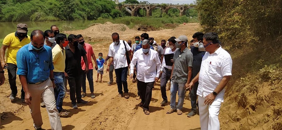 Kodagu District In-charge Minister V Somanna inspects the desilting work being carried out in River Cauvery in Kushalnagar on Friday.