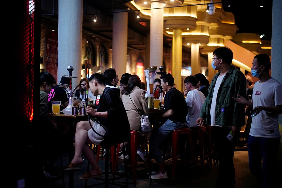 People wearing face masks are seen at a bar area in a nightclub after it reopens in Shanghai. Reuters