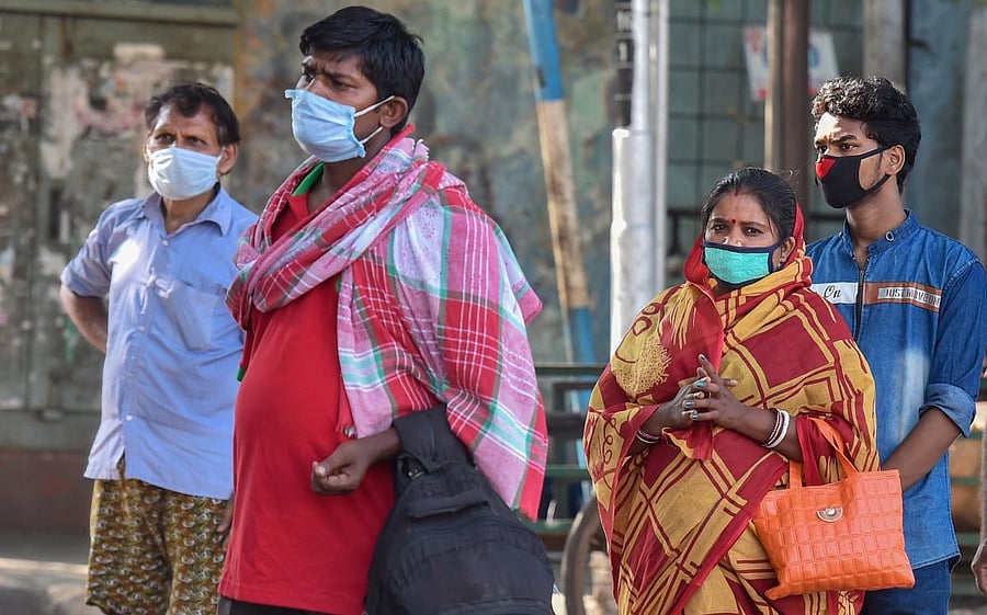  Migrants wait to board a bus to their native places in Bihar, during the fourth phase of the ongoing COVID-19 nationwide lockdown, in Kolkata, Monday, May 18, 2020. (PTI Photo)