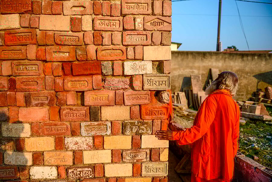 In this picture taken on November 12, 2019, a Sadhu (Hindu holy man) looks at bricks for the proposed Rama temple Ram Janmabhoomi Nyas workshop in Ayodhya, after the Supreme Court verdict on the disputed religious site. (AFP photo)