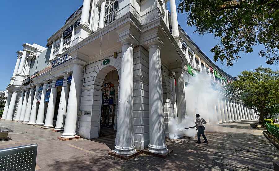 An NDMC worker uses fumigation machine at Connaught Place during a nationwide lockdown in the wake of coronavirus pandemic. (PTI Photo)