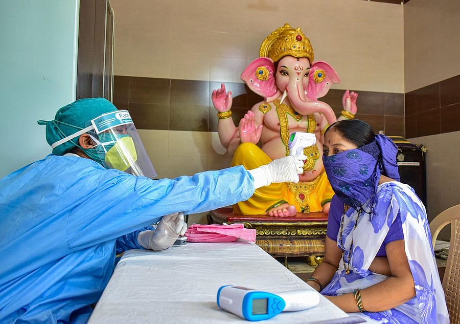 Medics conduct screening of residents at a camp, in wake of the coronavirus pandemic, during the ongoing nationwide lockdown, at a containment zone, in Solapur, Wednesday, May 27, 2020. (PTI Photo)