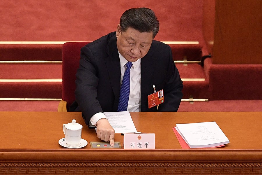 Chinese President Xi Jinping votes on a proposal to draft a security law on Hong Kong during the closing session of the National People's Congress at the Great Hall of the People in Beijing on May 28, 2020. (AFP Photo)