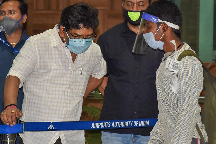 Jharkhand Chief Minister Hemant Soren (L) interacts with a migrant worker as he arrives at Birsa Munda International Airport, during the nationwide COVID-19 lockdown, in Ranchi. (PTI Photo)