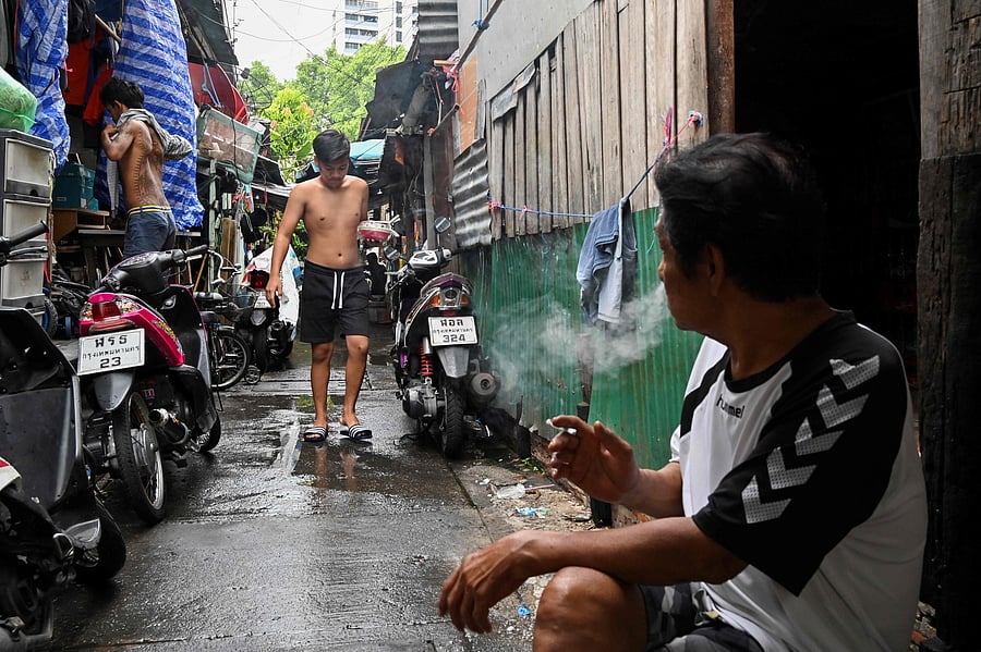 Shuffling around their tiny slum home which is too small to stand up in, a couple share donated noodles with their sons and worry about how they will pay the bills, as the coronavirus pushes Thailand's poor deeper into penury. (Photo by AFP)