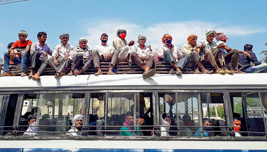Migrants travel in a crowded bus during the ongoing COVID-19 lockdown, in Gopalganj. (PTI photo)