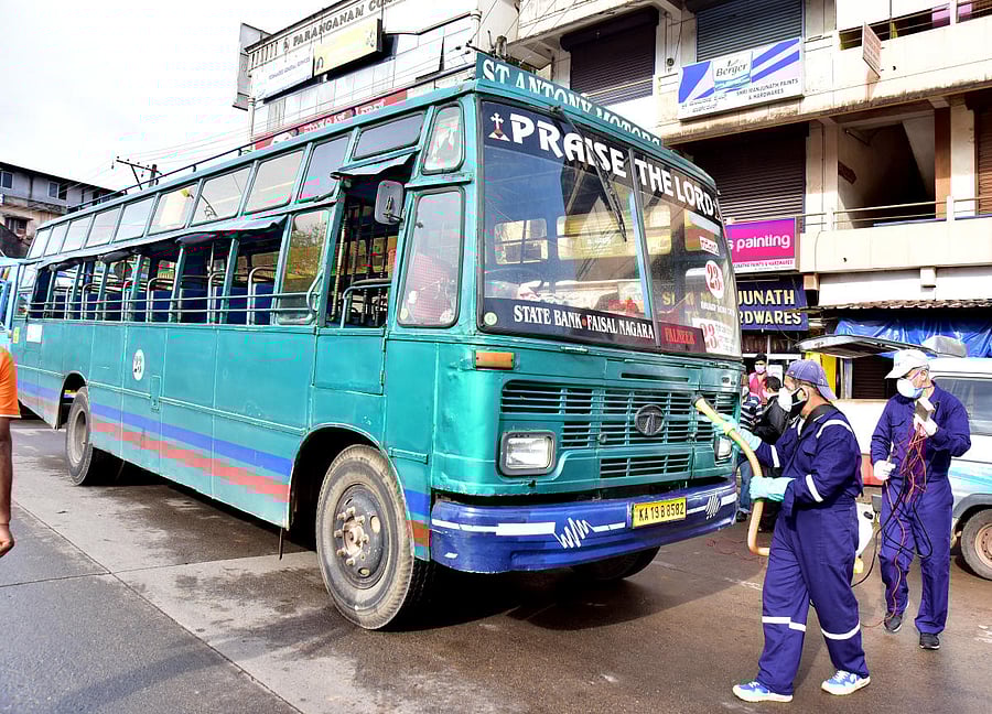 A private bus being sanitised prior to the journey at State Bank bus terminal in Mangaluru on Monday.