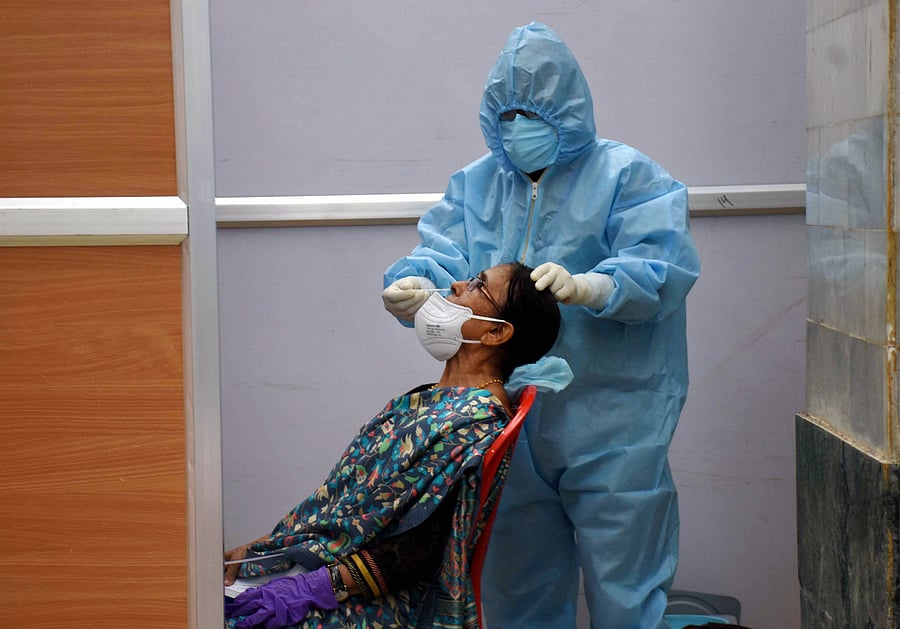 A passenger arriving from Kolkata being checked by a medic before he checks-out from the Maharaja Bir Bikram Airport, during ongoing COVID 19 lockdown in Agartala. (Credit: PTI Photo)