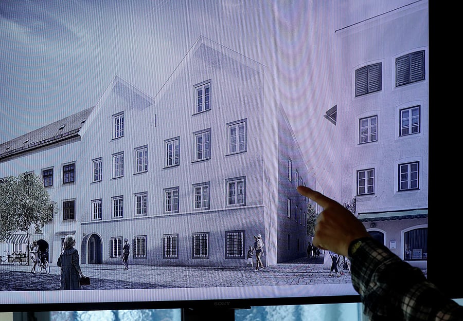 A man points on a tv screen showing the plan chosen for an architectural redesign of the house Adolf Hitler was born in during a news conference in Vienna, Austria June 2, 2020. Credit: Reuters