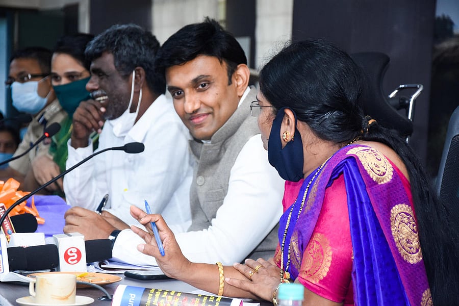 Medical Education Minister Dr K Sudhakar speaks at a meeting in DC’s office hall in Mangaluru on Wednesday.