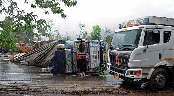 truck loaded with tiles overturned on the Charoti-Ahmedabad express highway during strong winds and heavy rain triggered by Cyclone Nisarga, in Palghar, Wednesday, June 3, 2020. (PTI Photo)