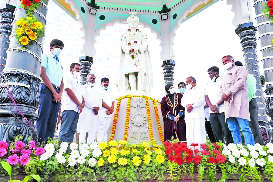 Dignitaries pay floral tributes to the statue of Nalvadi Krishnaraja Wadiyar on his 136th Jayanti at KR Circle in Mysuru on Thursday. Deputy Commissioner Abhiram G Sankar, MLA L Nagendra, District in-charge Minister S T Somashekar, MLA S A Ramadass, Mayor