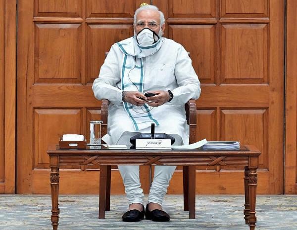 Prime Minister Narendra Modi wearing a face mask chairs a cabinet meeting in New Delhi. (PTI Photo)