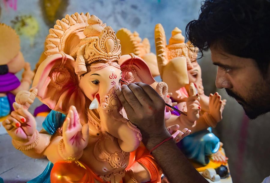 An artist gives final touches to an idol of Lord Ganesh at a unit at Hamrapur village in Pen Taluka of Raigad district, Monday, May 25, 2020. (PTI)