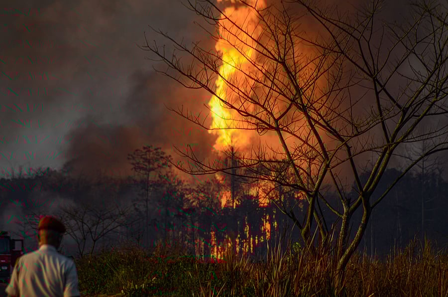 Smoke billows from a fire at Baghjan oil field, a week after a blowout, in Tinsukia district. Credits: PTI Photo