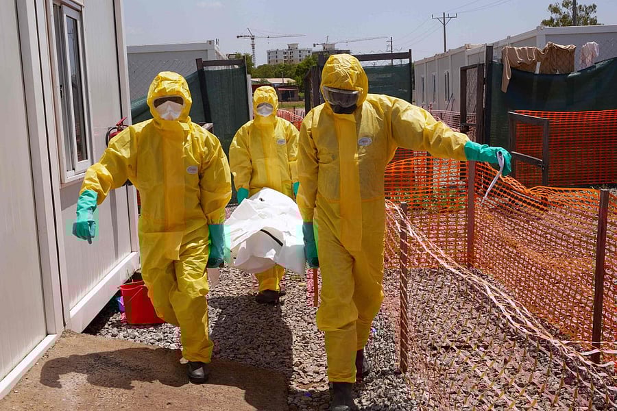 Members of International Medical Corps (IMC) carry the body of a patient on a stretcher who has just died from the COVID-19 coronavirus at a Ministry of Health Infectious Disease Unit in Juba, South Sudan on May 28, 2020. Credit/AFP